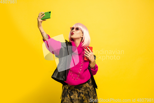 Image of Caucasian woman\'s portrait isolated on yellow studio background, influencer be like