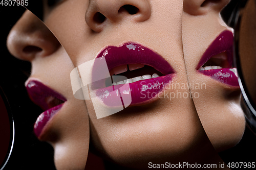 Image of beautiful woman lips closeup with mirror reflections