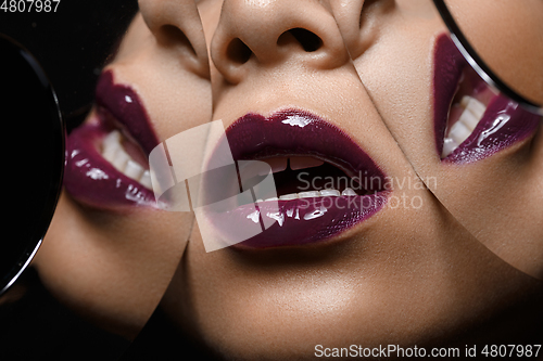 Image of beautiful woman lips closeup with mirror reflections