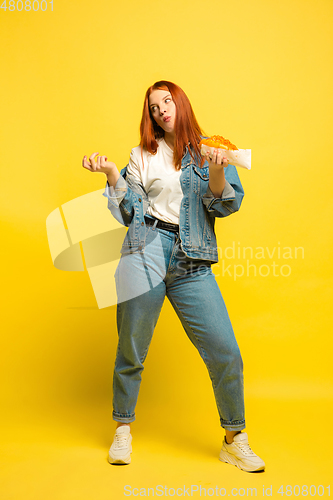 Image of Caucasian woman\'s portrait isolated on yellow studio background, follower be like