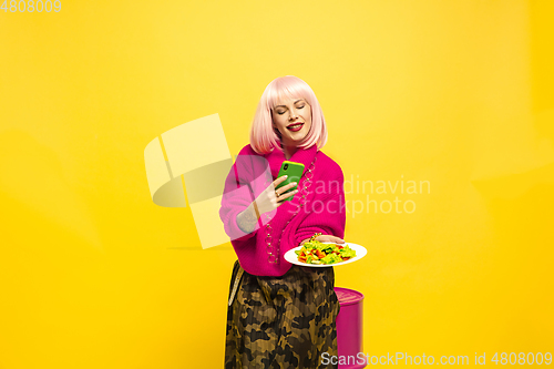 Image of Caucasian woman\'s portrait isolated on yellow studio background, influencer be like