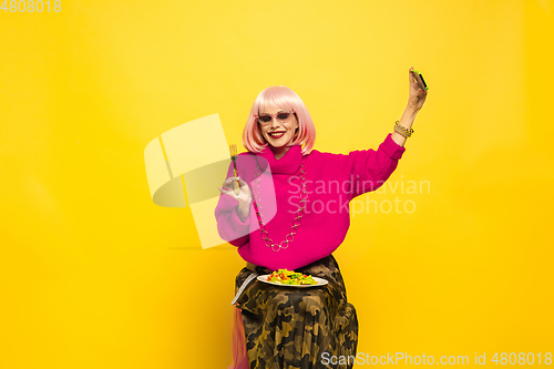 Image of Caucasian woman\'s portrait isolated on yellow studio background, influencer be like