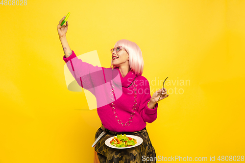 Image of Caucasian woman\'s portrait isolated on yellow studio background, influencer be like