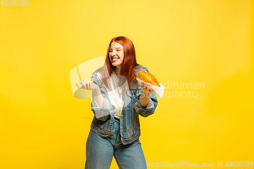 Image of Caucasian woman\'s portrait isolated on yellow studio background, follower be like