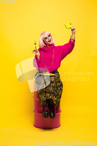 Image of Caucasian woman\'s portrait isolated on yellow studio background, influencer be like