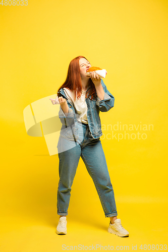 Image of Caucasian woman\'s portrait isolated on yellow studio background, follower be like