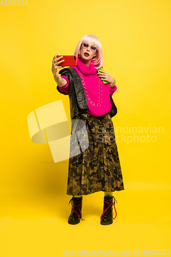 Image of Caucasian woman\'s portrait isolated on yellow studio background, influencer be like