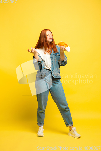 Image of Caucasian woman\'s portrait isolated on yellow studio background, follower be like