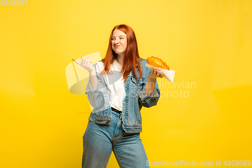 Image of Caucasian woman\'s portrait isolated on yellow studio background, follower be like