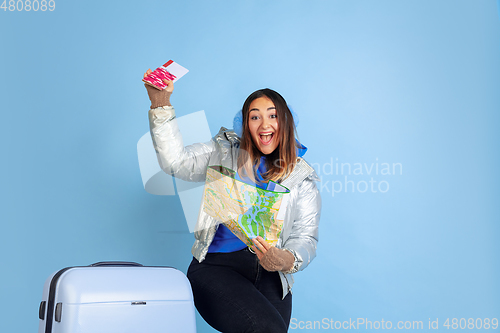 Image of Caucasian woman\'s portrait isolated on blue studio background, winter theme