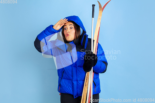 Image of Caucasian woman\'s portrait isolated on blue studio background, winter theme