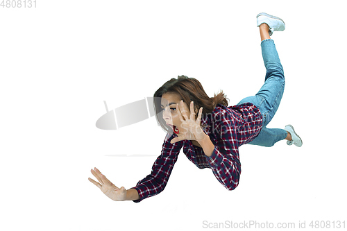 Image of A second before falling - young girl falling down with bright emotions and expression