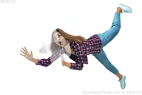 Image of A second before falling - young girl falling down with bright emotions and expression
