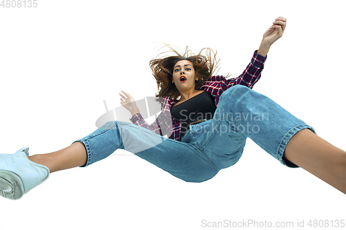 Image of A second before falling - young girl falling down with bright emotions and expression