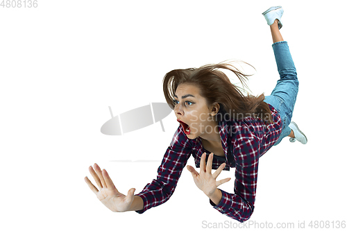 Image of A second before falling - young girl falling down with bright emotions and expression