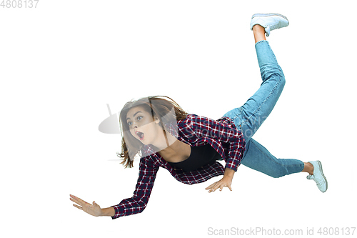 Image of A second before falling - young girl falling down with bright emotions and expression