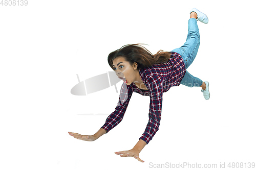 Image of A second before falling - young girl falling down with bright emotions and expression