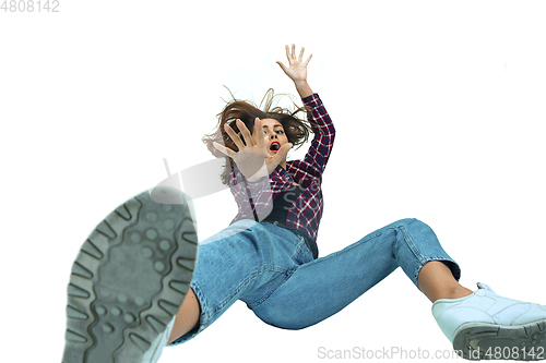 Image of A second before falling - young girl falling down with bright emotions and expression