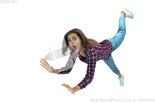 Image of A second before falling - young girl falling down with bright emotions and expression