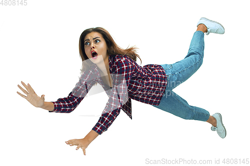 Image of A second before falling - young girl falling down with bright emotions and expression