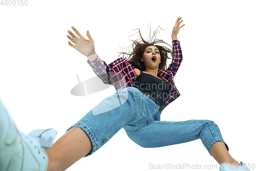 Image of A second before falling - young girl falling down with bright emotions and expression