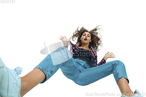 Image of A second before falling - young girl falling down with bright emotions and expression