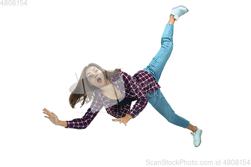 Image of A second before falling - young girl falling down with bright emotions and expression