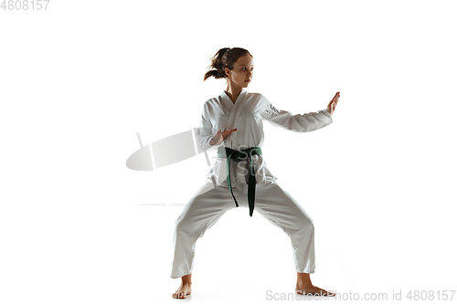 Image of Confident junior in kimono practicing hand-to-hand combat, martial arts