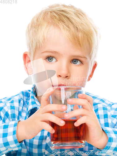 Image of Little boy with glass of cherry juice