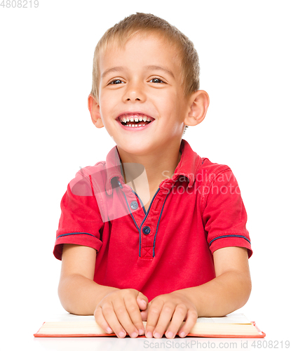 Image of Little boy is reading a book