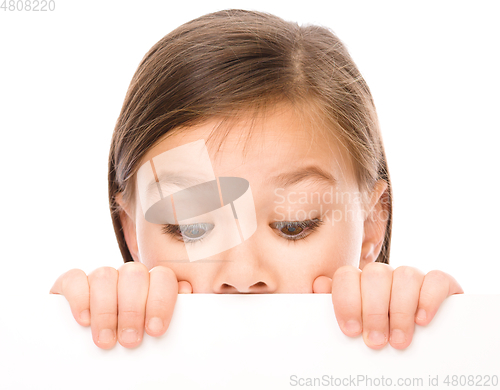 Image of Little girl is looking from out blank board