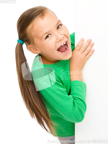 Image of Little girl is looking from out blank board