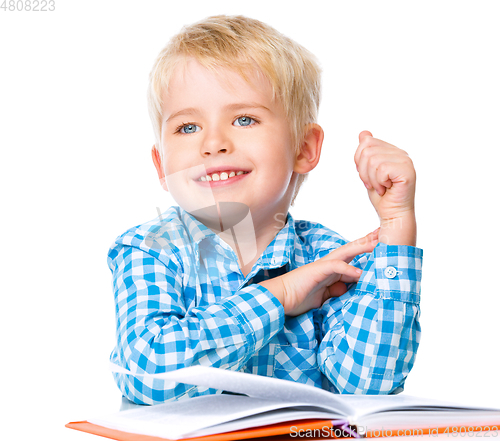 Image of Little child play with book