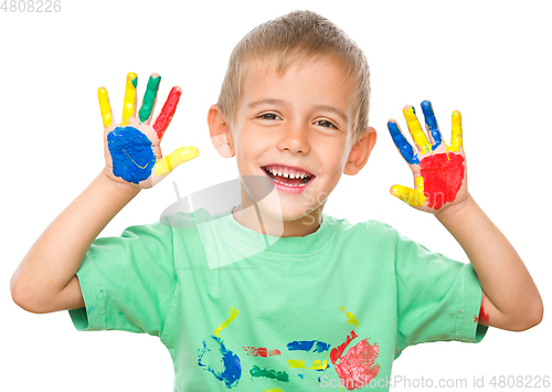 Image of Portrait of a cute boy playing with paints