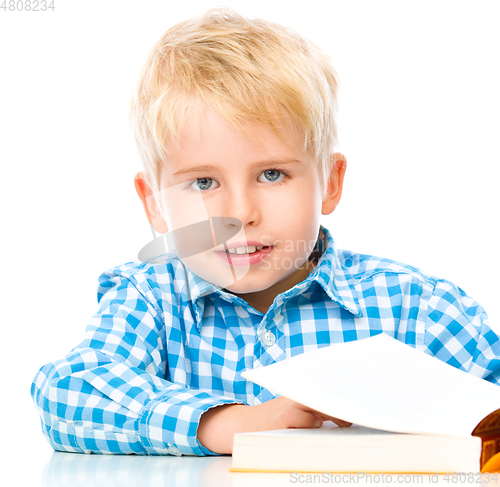 Image of Little child play with book