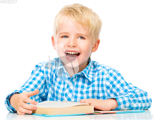 Image of Little child play with book