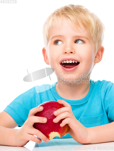 Image of Portrait of a cute little boy with red apple