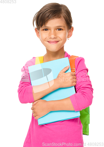 Image of Young girl is holding book