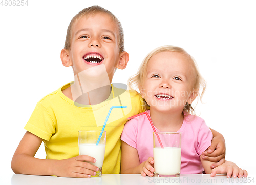 Image of Cute little girl and boy are drinking milk