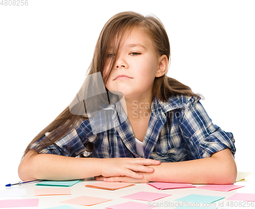 Image of Girl is writing on color stickers
