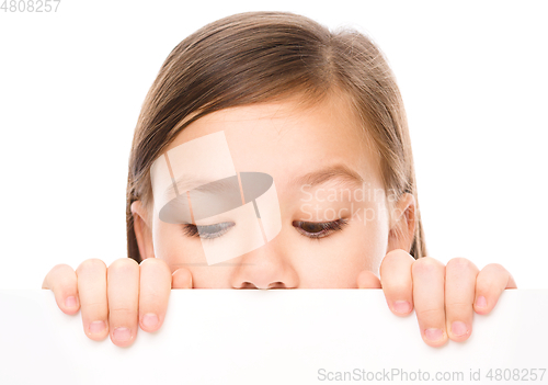 Image of Little girl is looking from out blank board