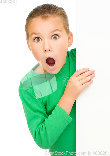 Image of Little girl is looking out from the blank banner