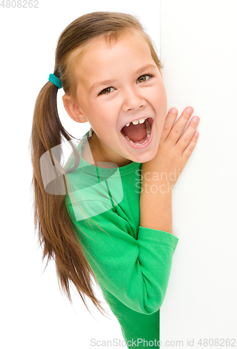 Image of Little girl is looking from out blank board