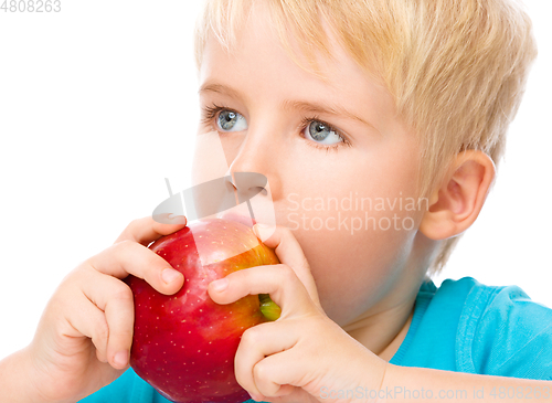 Image of Portrait of a cute little boy with red apple