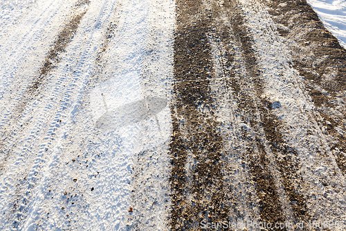 Image of the snow-covered asphalt road close up