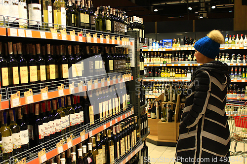 Image of woman choises Store of alcoholic drinks