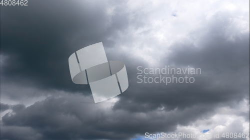 Image of Time lapse Nature background Ominous clouds drift slowly across the sky, threatening rain. UltraHD stock footage