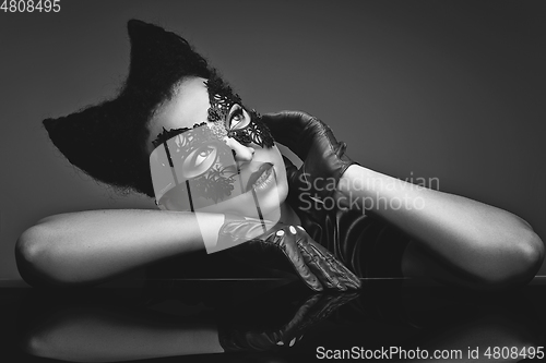 Image of girl with horns hairstyle in leather mask