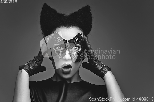 Image of girl with horns hairstyle in leather mask