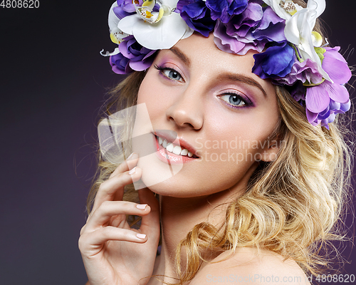 Image of beautiful blond girl with flowers